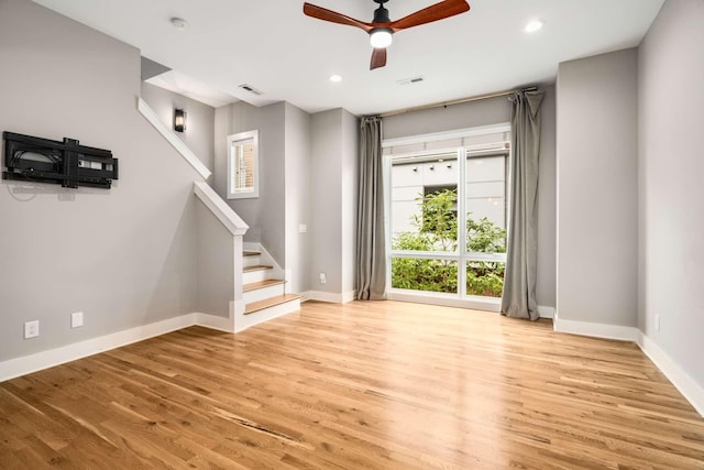 unfurnished living room featuring ceiling fan and light wood-type flooring