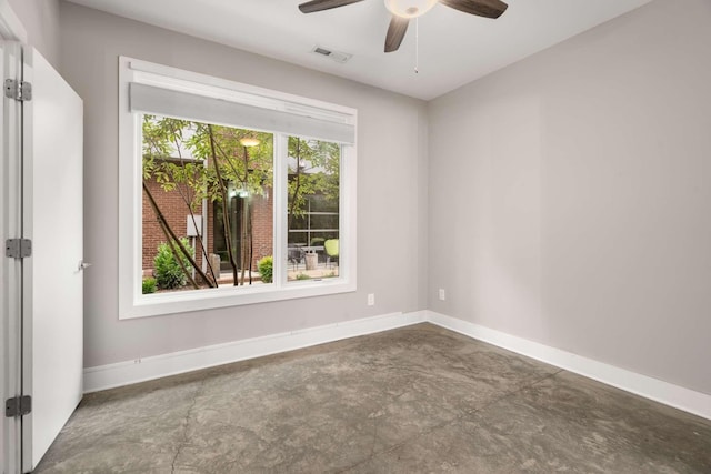 spare room featuring ceiling fan and a healthy amount of sunlight