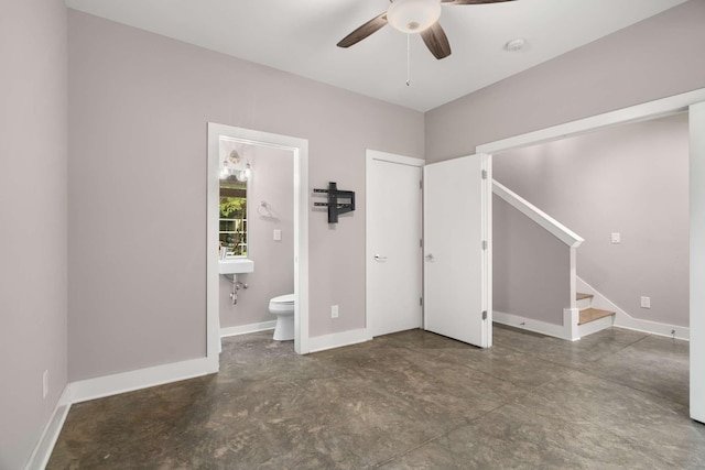 unfurnished bedroom featuring connected bathroom and ceiling fan