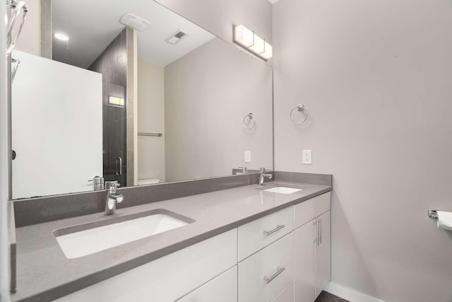 bathroom with vanity, an enclosed shower, and toilet