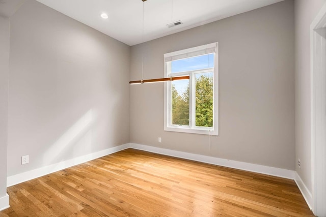 empty room with hardwood / wood-style floors