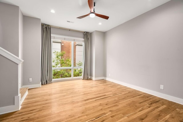 unfurnished room featuring ceiling fan and light hardwood / wood-style flooring