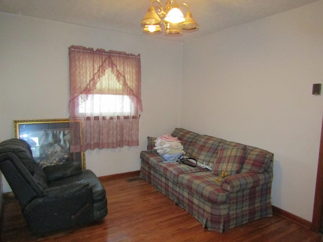 living room with a notable chandelier and wood-type flooring