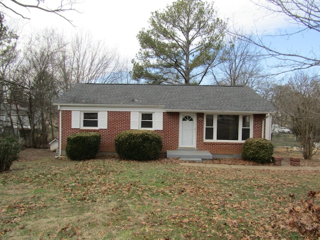 single story home featuring a front lawn