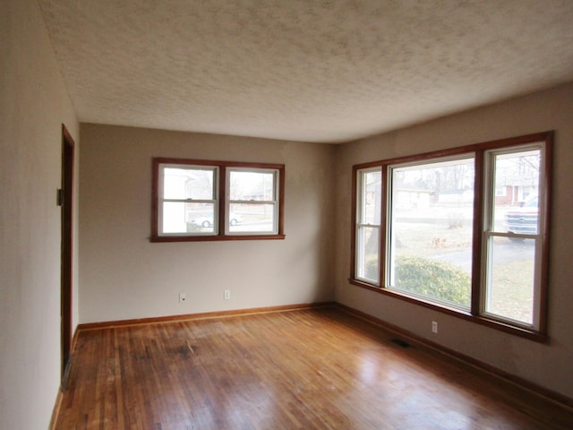 spare room with hardwood / wood-style flooring