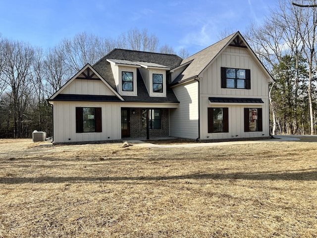 modern farmhouse with central AC unit and a front lawn