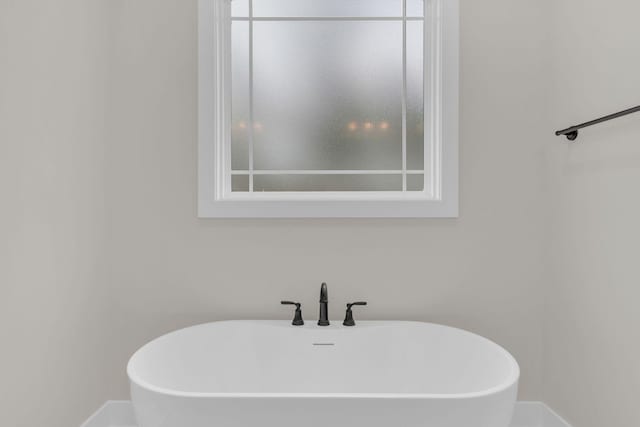 bathroom featuring a tub to relax in