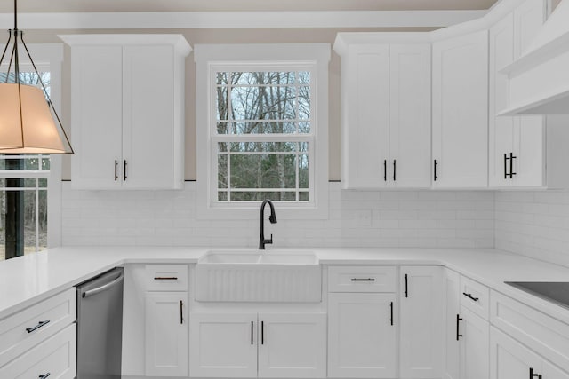 kitchen featuring sink, dishwasher, custom range hood, white cabinets, and decorative light fixtures