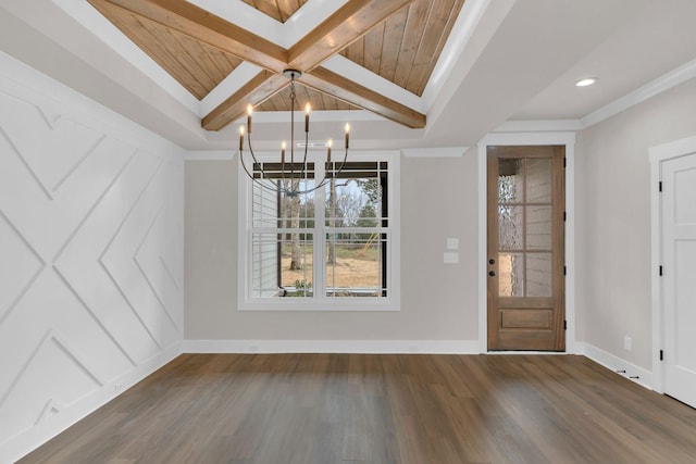 entrance foyer featuring a notable chandelier, beam ceiling, ornamental molding, and dark hardwood / wood-style floors