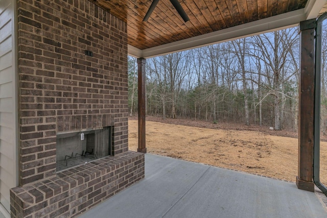 view of patio / terrace featuring an outdoor brick fireplace