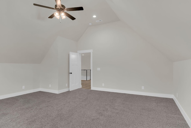 additional living space with ceiling fan, vaulted ceiling, and carpet