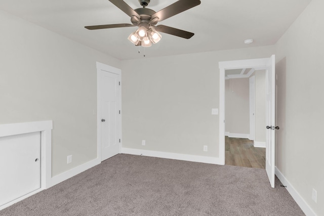 spare room featuring light colored carpet and ceiling fan