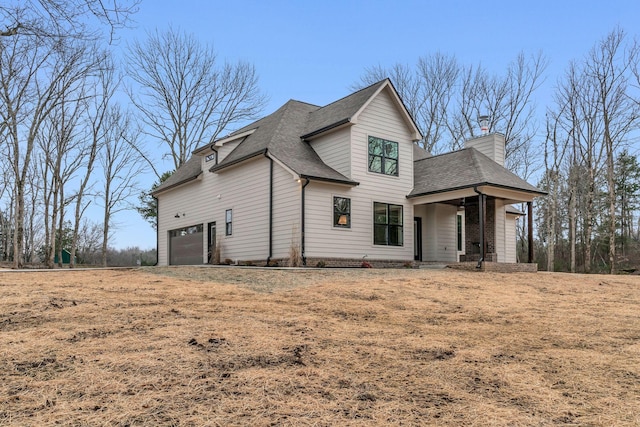 view of front facade with a garage, a porch, and a front yard