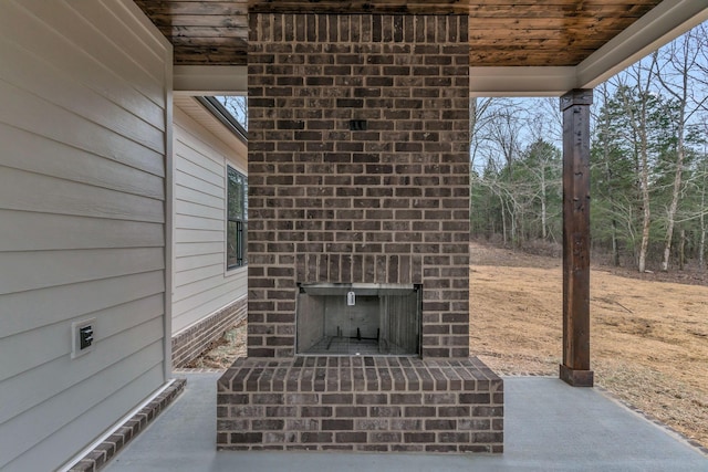 view of patio / terrace with an outdoor brick fireplace