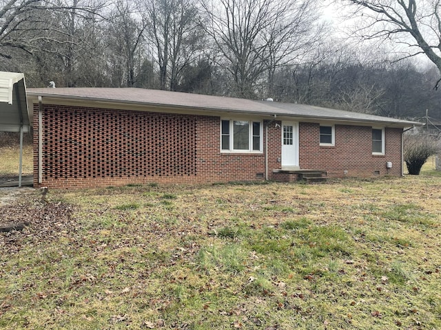 rear view of property featuring a yard