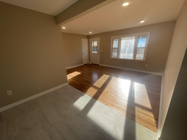 unfurnished room featuring recessed lighting, baseboards, and wood finished floors