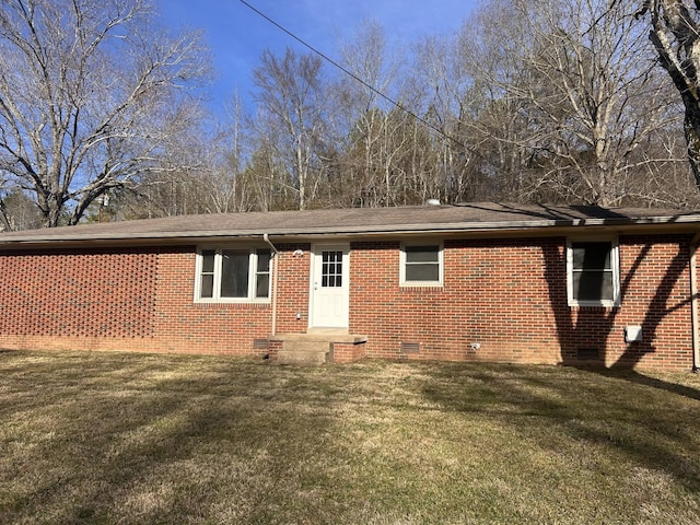 ranch-style house with crawl space, brick siding, and a front yard