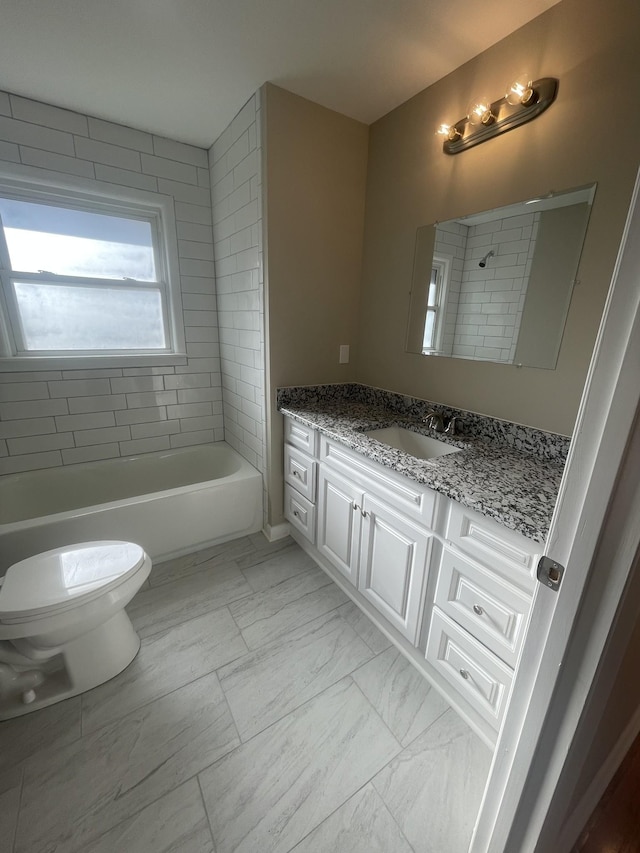 full bathroom featuring toilet, marble finish floor, a shower, a bath, and vanity