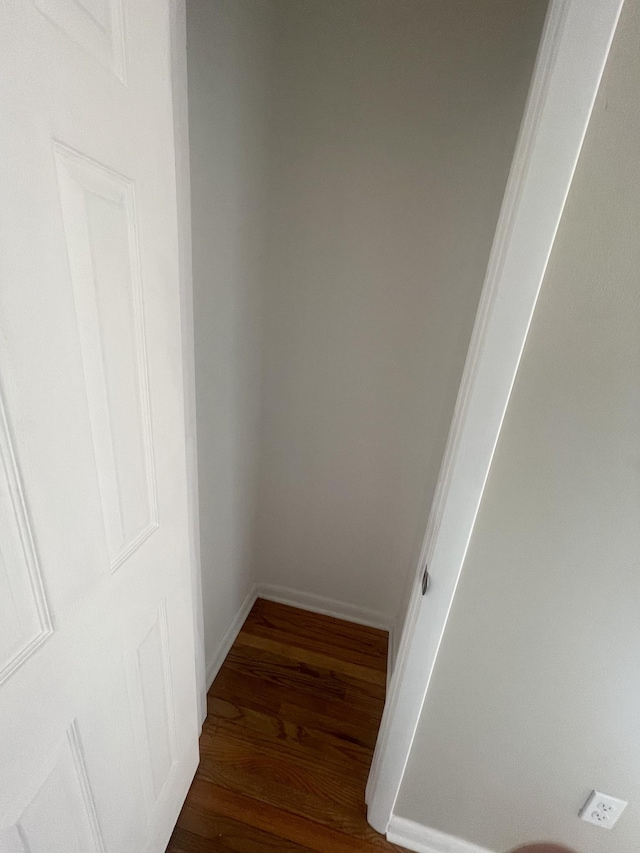 interior space with baseboards and wood finished floors