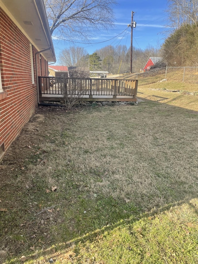 view of yard with fence and a wooden deck