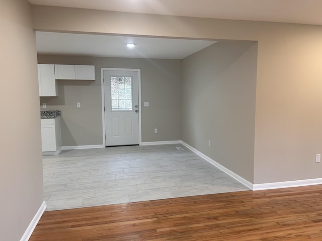 entryway featuring baseboards and light wood finished floors