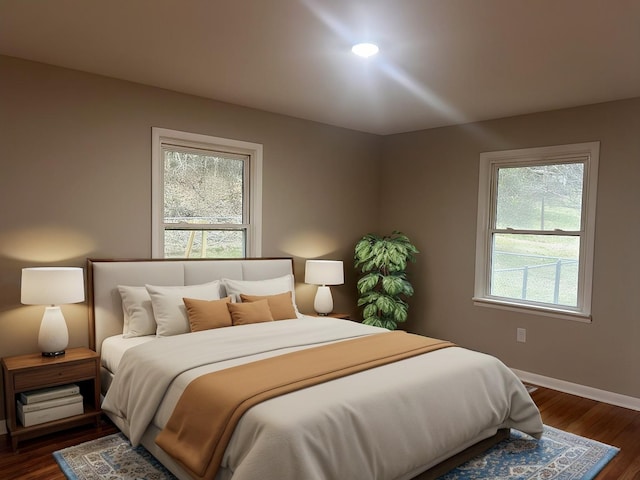 bedroom featuring dark wood finished floors and baseboards