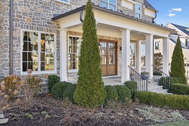 view of exterior entry featuring covered porch