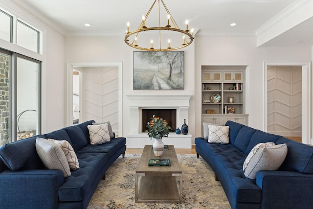 living room featuring built in shelves, plenty of natural light, crown molding, and a chandelier