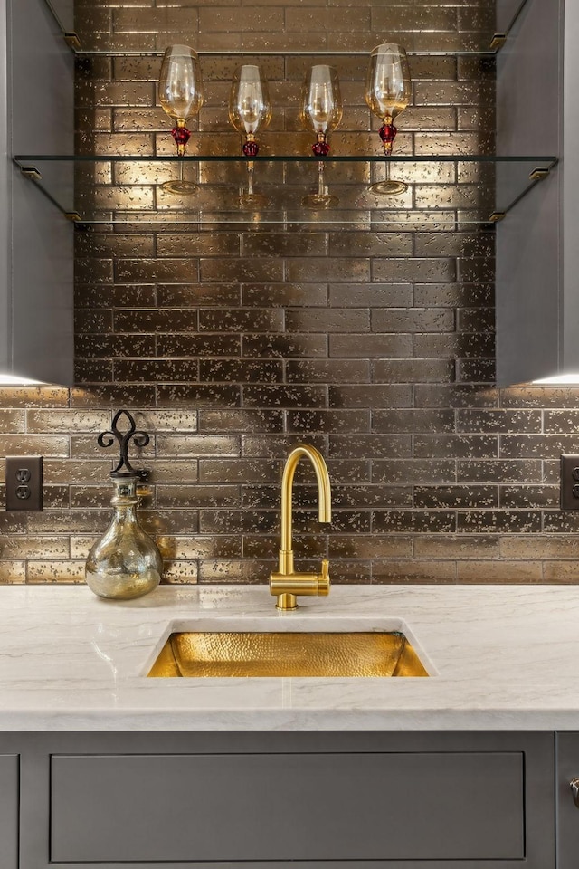 bar with sink and gray cabinetry