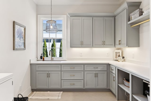 kitchen featuring sink, decorative light fixtures, and gray cabinets