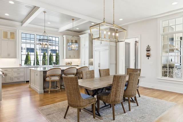 dining space with an inviting chandelier, beam ceiling, light hardwood / wood-style flooring, and wooden ceiling