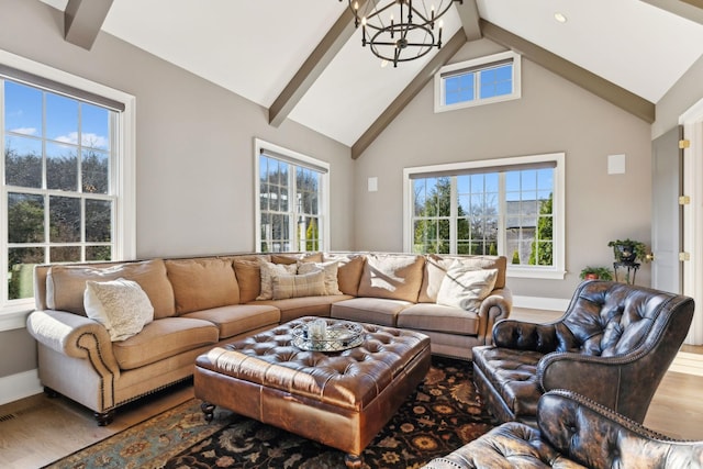 living room featuring lofted ceiling with beams, hardwood / wood-style floors, and a chandelier