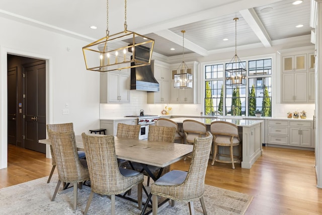 dining room with wooden ceiling, light wood-type flooring, a notable chandelier, and beam ceiling