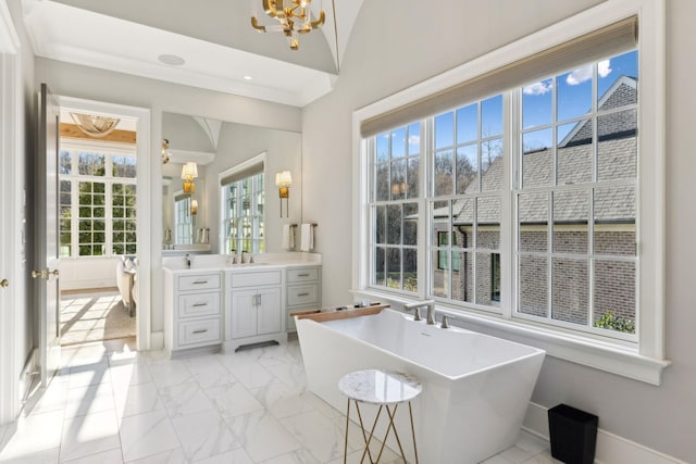 bathroom with vanity, a wealth of natural light, vaulted ceiling, and a washtub