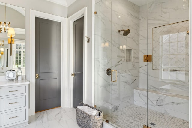 bathroom featuring an enclosed shower and a notable chandelier