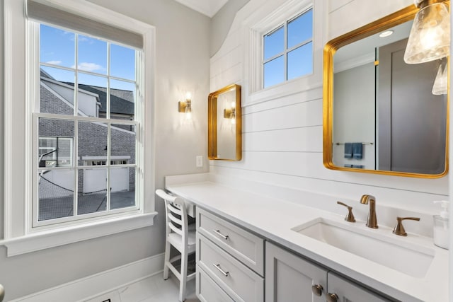 bathroom with tile patterned floors, vanity, and a wealth of natural light