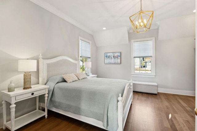 bedroom featuring multiple windows, hardwood / wood-style floors, lofted ceiling, and a chandelier