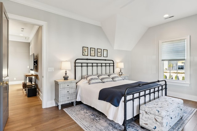 bedroom featuring ornamental molding, dark hardwood / wood-style floors, and vaulted ceiling