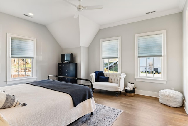 bedroom featuring ornamental molding, lofted ceiling, ceiling fan, and light hardwood / wood-style floors