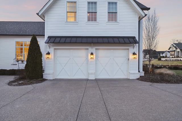 property exterior at dusk with a garage