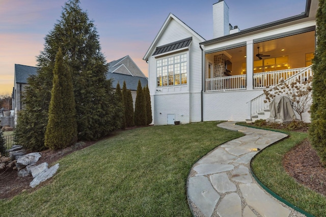 yard at dusk with ceiling fan