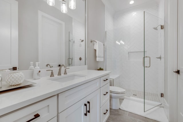 bathroom featuring vanity, toilet, an enclosed shower, and tile patterned flooring