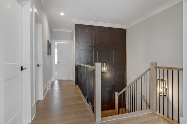 hallway featuring crown molding and light wood-type flooring