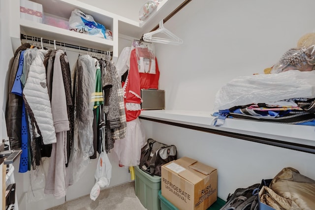 walk in closet featuring light colored carpet