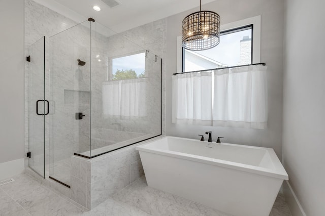 bathroom featuring plenty of natural light and independent shower and bath