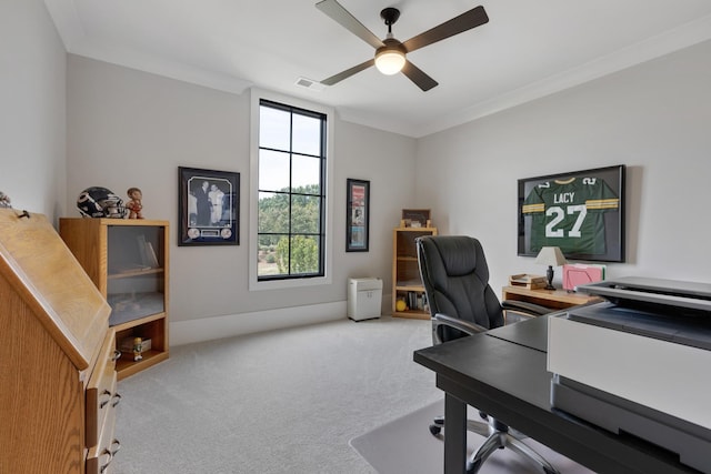 carpeted office space featuring ornamental molding and ceiling fan