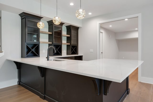 kitchen featuring decorative light fixtures, a kitchen breakfast bar, and kitchen peninsula