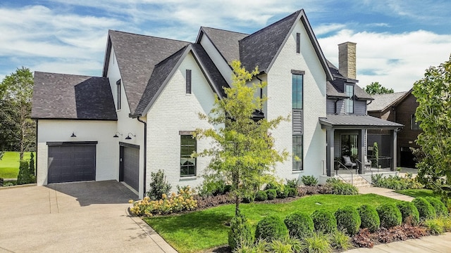 view of home's exterior featuring a yard, a garage, and a porch