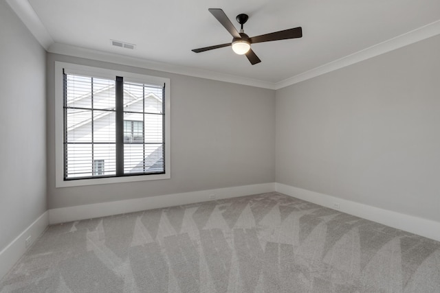 carpeted empty room featuring crown molding and ceiling fan