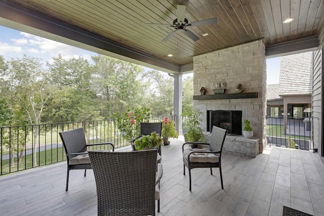 view of patio / terrace with ceiling fan and an outdoor stone fireplace